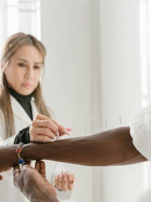 Acupuncture therapy session featuring therapist and patient focusing on wellness.